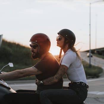 Motorcyclists at sunset man and woman