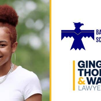Young woman smiling outdoors with law firm branding