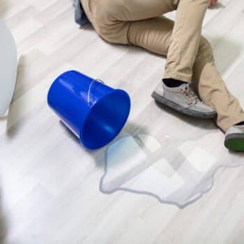 Photo of a wet floor and person slipped next to the bucket