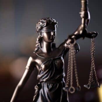 Photo of lady justice statue standing on the table