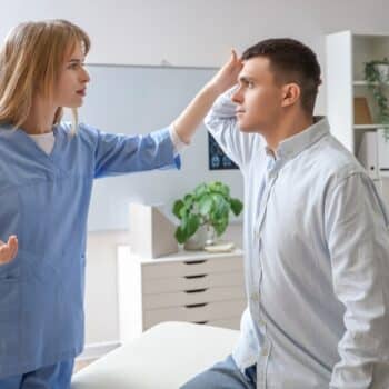 Doctor Examining A Patients Head