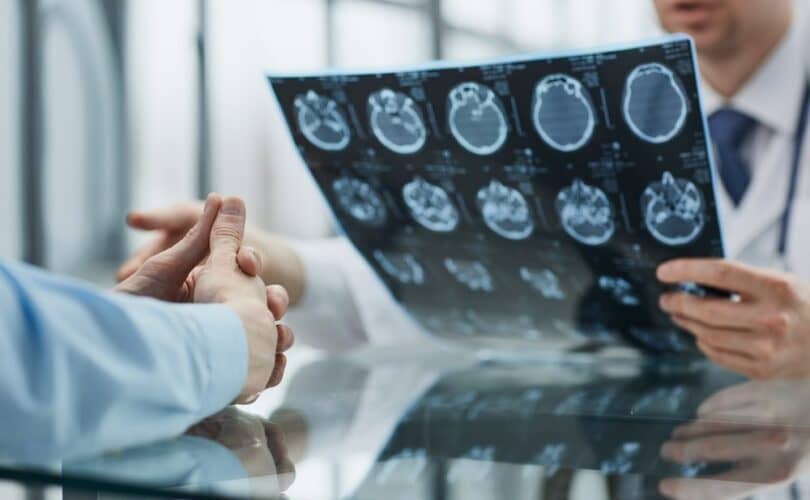 Doctor Looking At Brain Scans With His Client