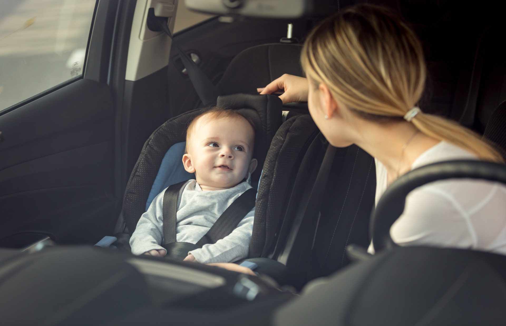 Mother is comforting child in the car